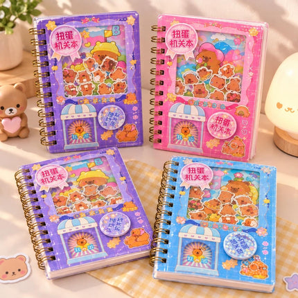 Capybara diary notebooks with spiral binding and purple pink and blue covers on a desk