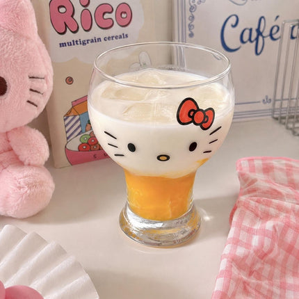 Two clear Hello Kitty stemmed drinking glasses with character face print and pink drinks