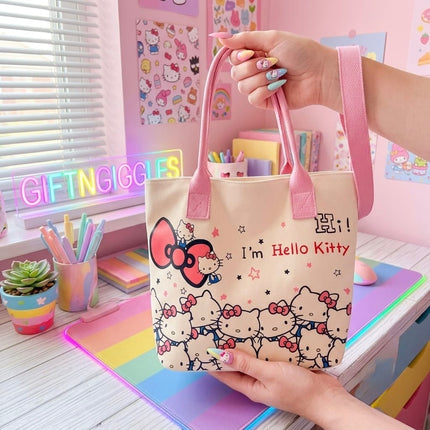Front of Hello Kitty tote bag showing pink handles, bow, stars and character print
