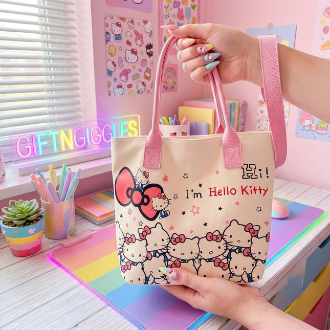 Front of Hello Kitty tote bag showing pink handles, bow, stars and character print