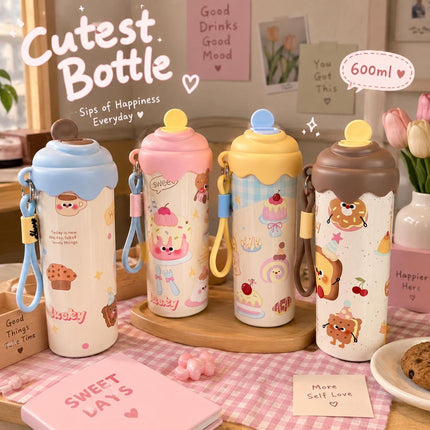 Four cute illustrated steel bottles in blue, pink, yellow and brown with rounded lids and carry straps