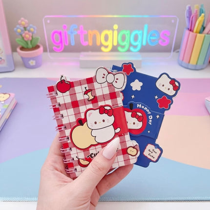 Open Hello Kitty A7 diary showing ruled cream pages