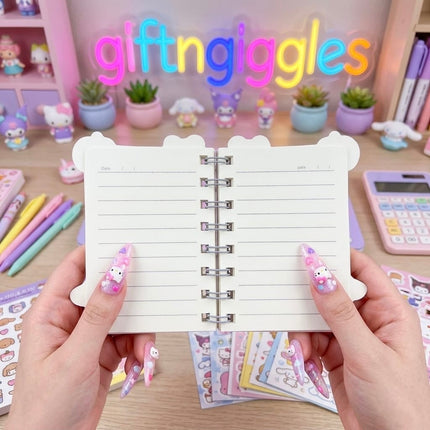 Open Kuromi spiral mini diary showing lined pages with date spaces