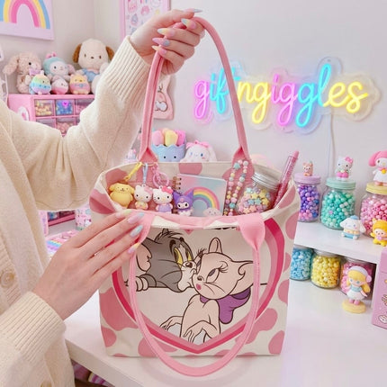 Tom and Toodles Galore pink tote bag shown open with styling accessories inside