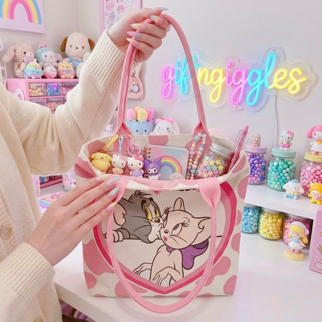 Tom and Toodles Galore pink tote bag shown open with styling accessories inside