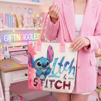 Stitch tote bag with pink handles carried against a pink outfit