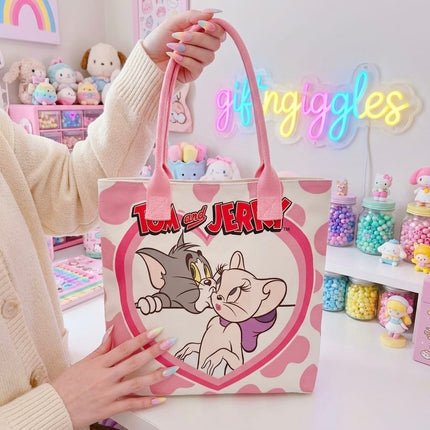 Pink and cream tote bag with Tom and Toodles Galore inside a heart and Tom and Jerry logo