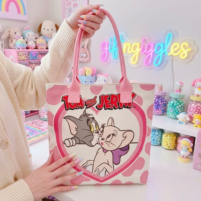 Pink and cream tote bag with Tom and Toodles Galore inside a heart and Tom and Jerry logo