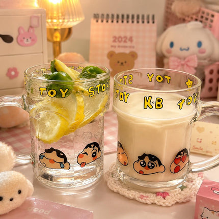 Two clear Shinchan character glass mugs with handles, yellow lettering and cartoon face print