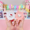 White Hello Kitty-style cat-ear handheld mirror and matching comb with red bows