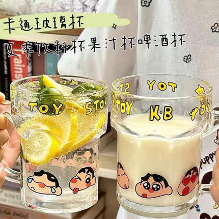 Close-up of clear handled Shinchan mugs showing yellow lettering and multiple character expressions