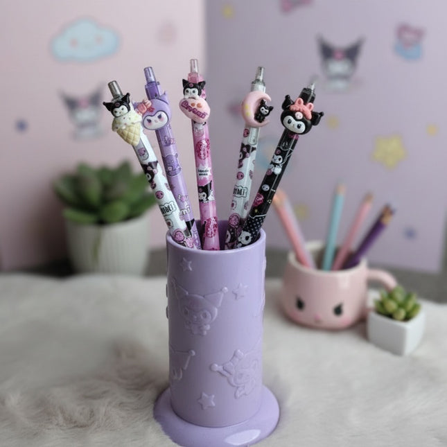 Purple pen holder with cartoon-themed pens on a light pink surface.